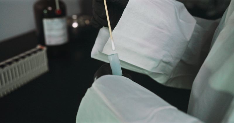 Collecting a wipe sample with a leak test swab
